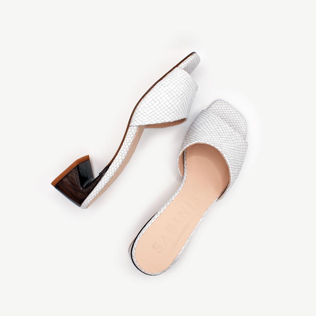 par de sandalias mule Essential White Python de marca Sabinis, en piel blanca con textura pitón, tacón cómodo bajo
